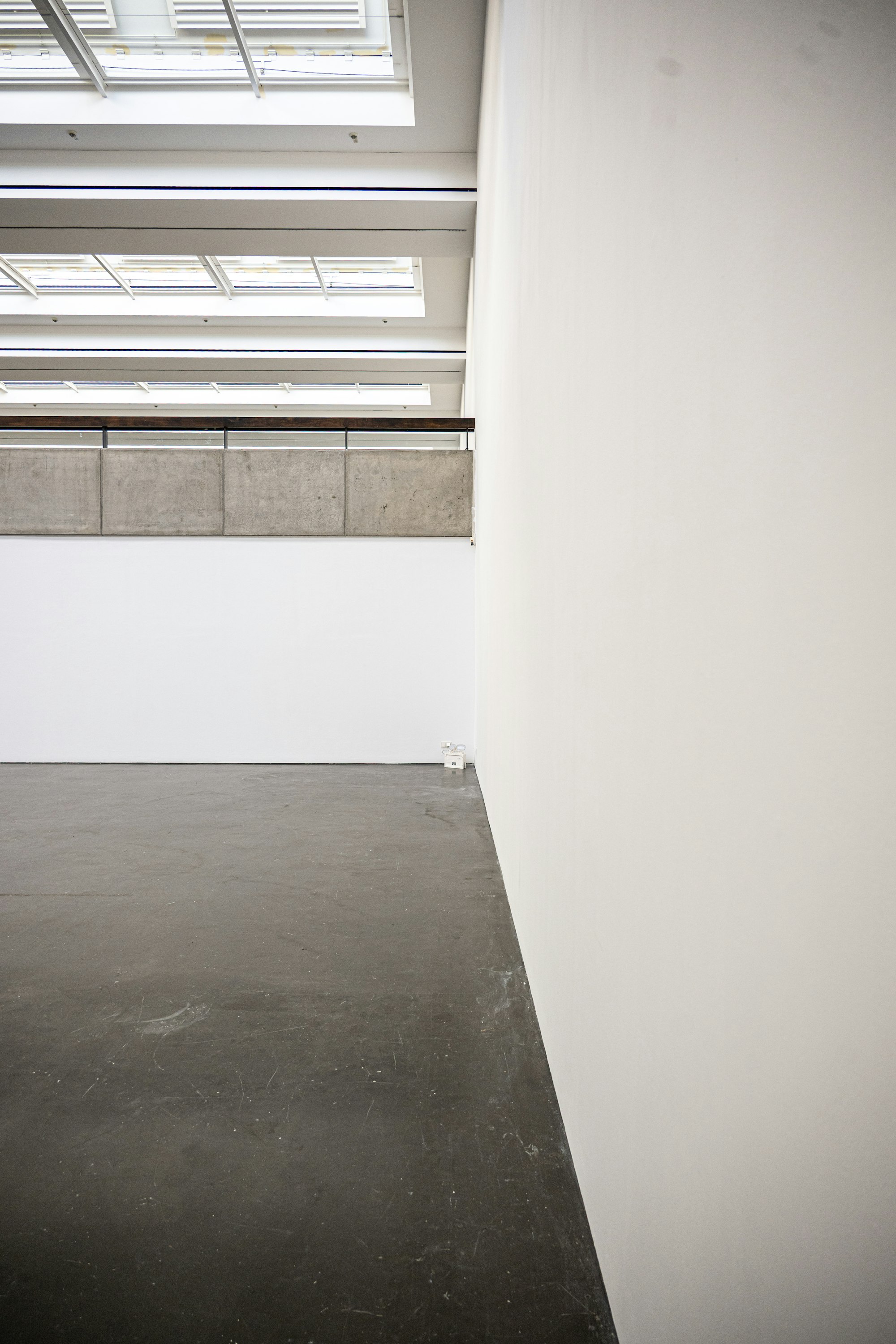 Minimal concrete and white gallery interior with sharply framed openings